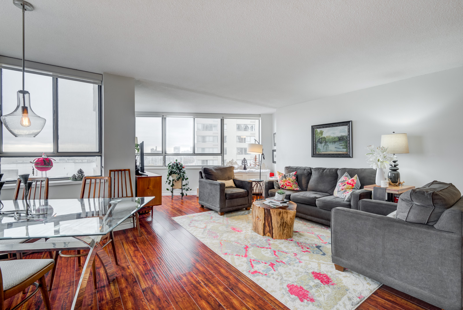 Living room with dark gray sofas, carpet and large windows.