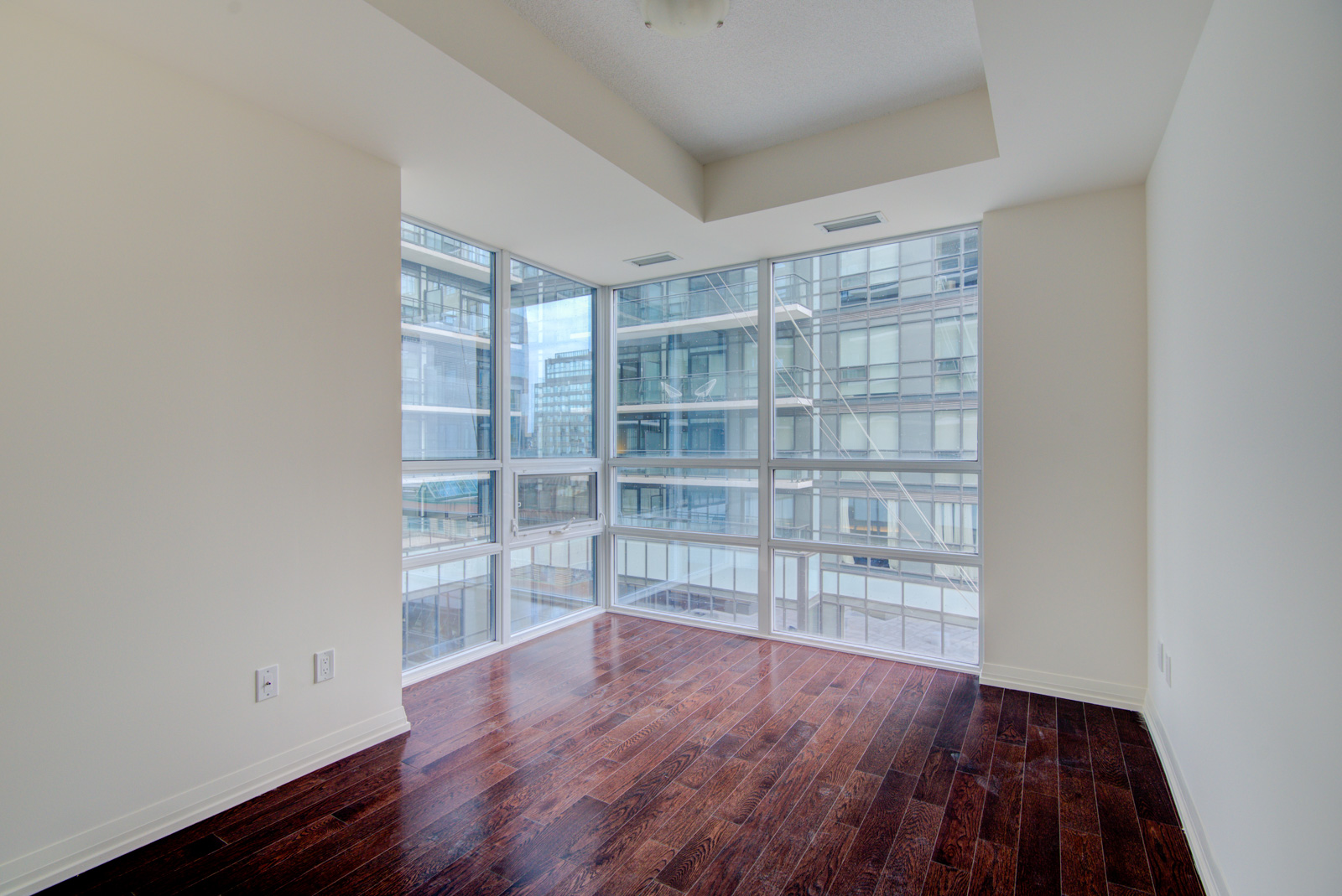 Another photo of master bedroom and windows and floors