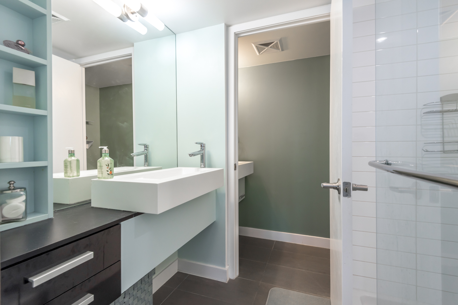 Photo of master bath and sink and cabinets and drawers.