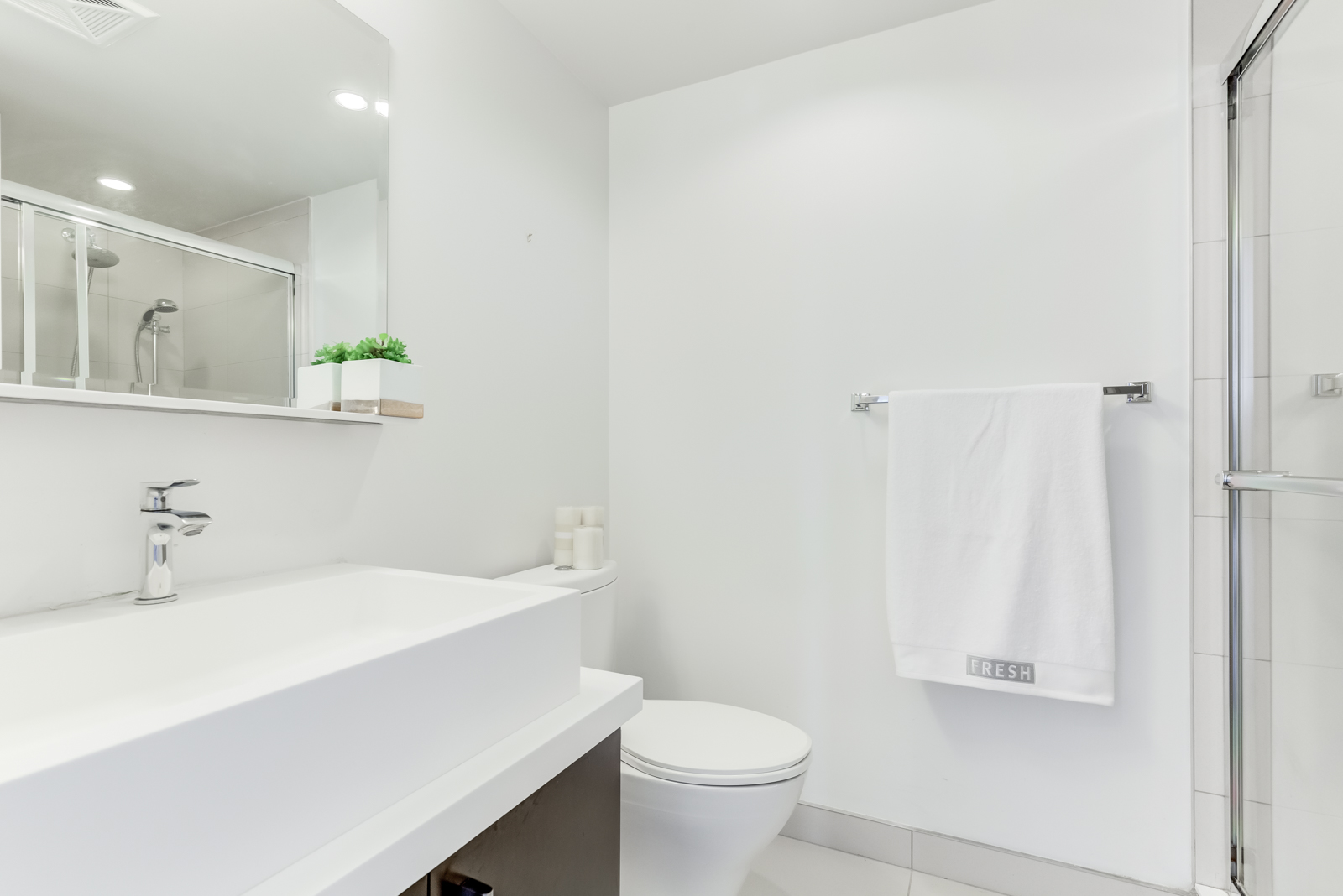 2nd bathroom with sink, shower and vanity.