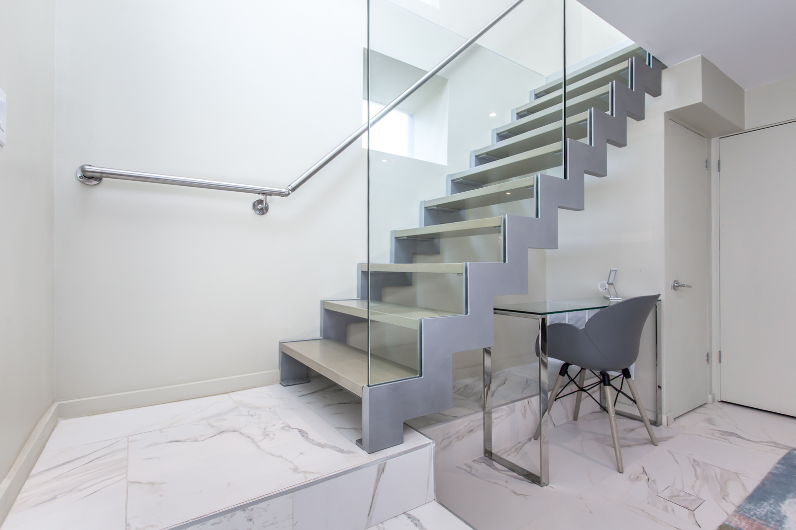 Another angle of staircase and we also see the office desk and chair.