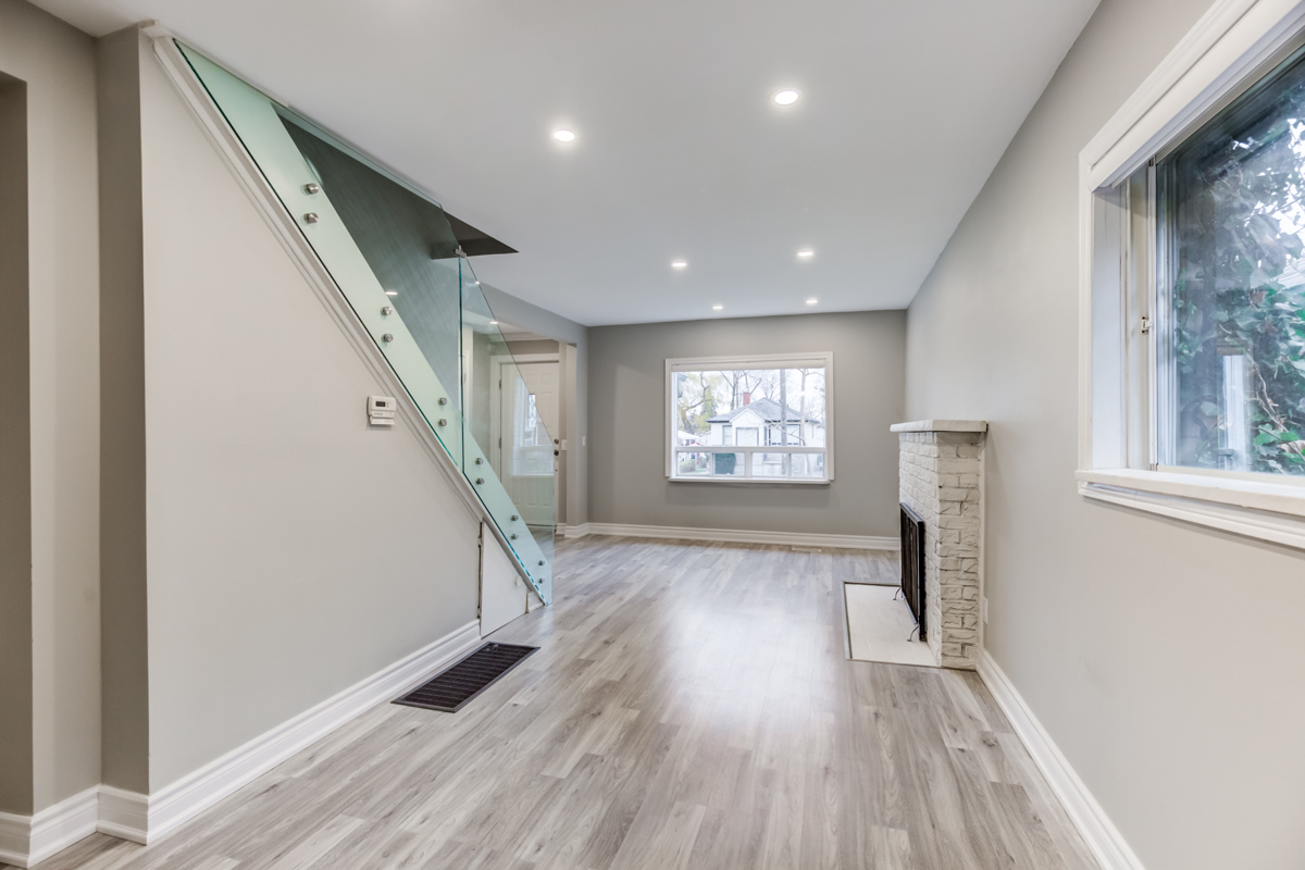 54 Huntington Ave – new pot-lights, glass-paneled stairs, gray walls and laminate floors.