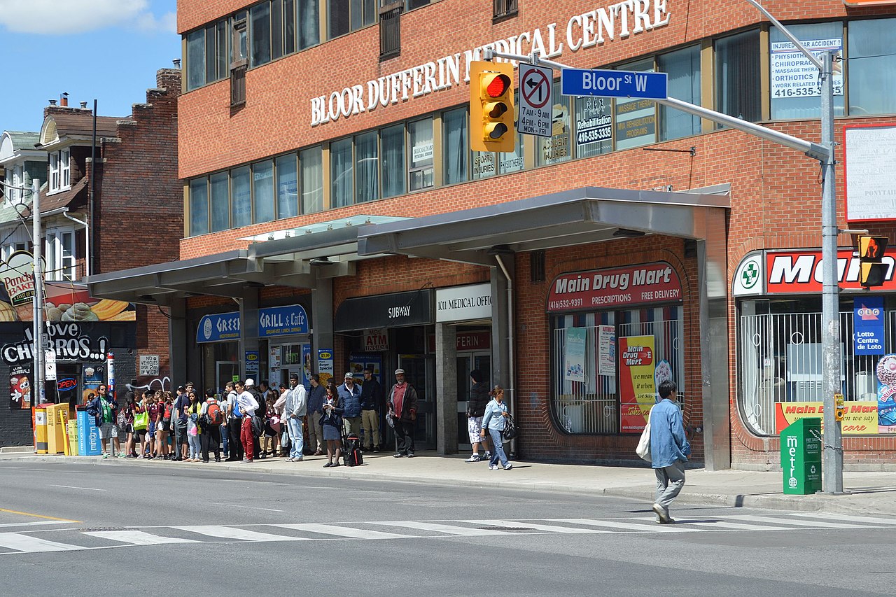 Pedestrians and storefronts along Dovercourt Wallace Emerson Junction.