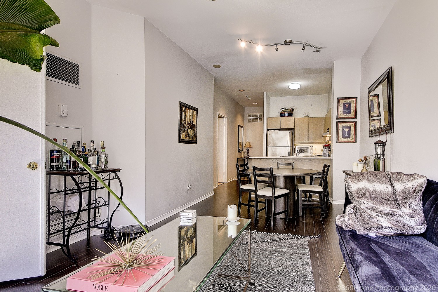 Photo of living room, dining room and kitchen crowded with furniture.