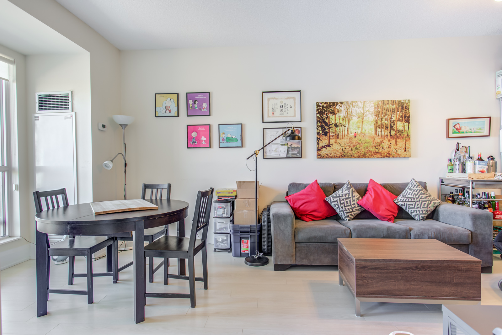 Another angle of 120 Harrison Garden Unit 1025 living and dining area; we can see paintings and pictures on walls.