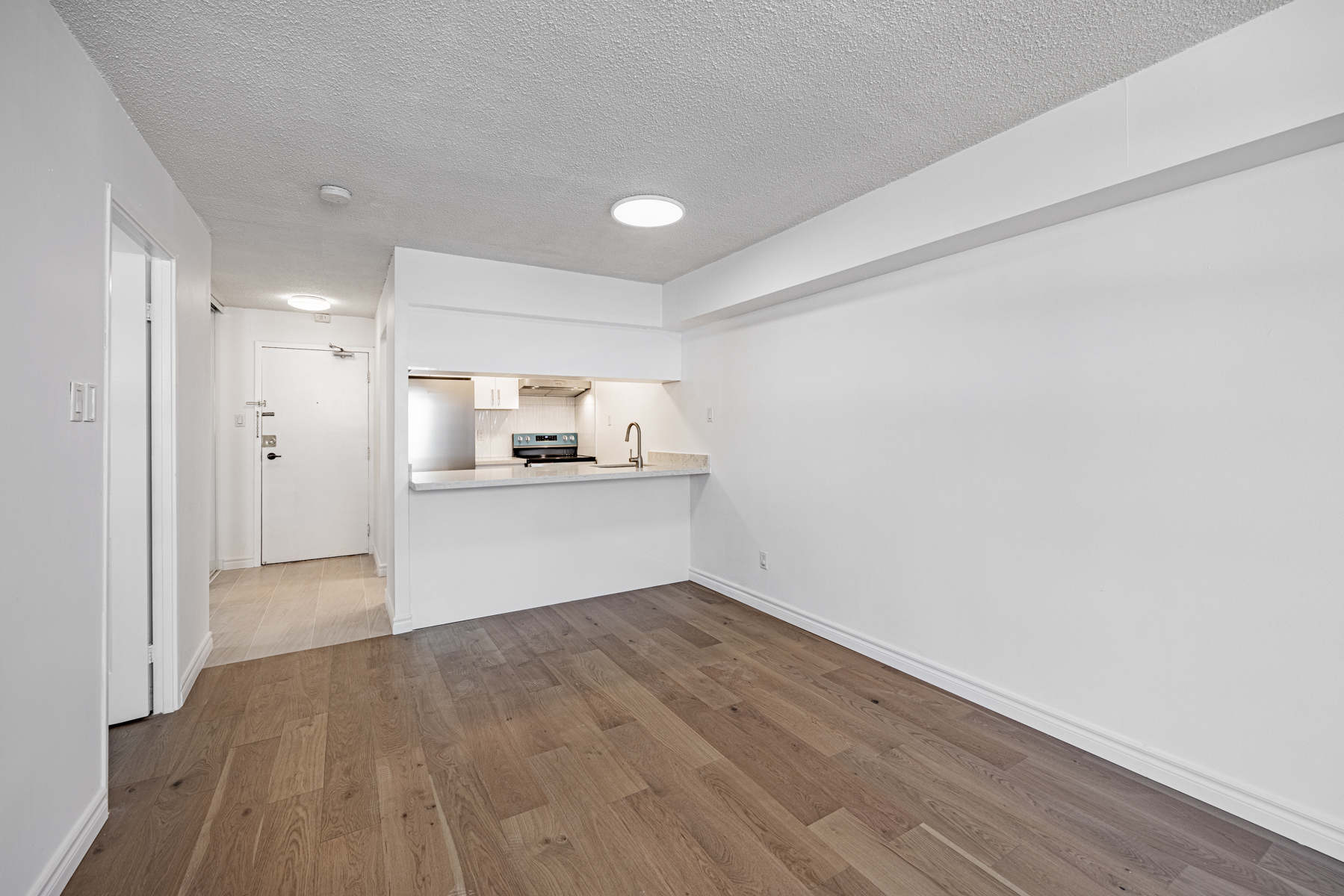 Dining room with thin ceiling lamp – 120 St Patrick Unit 807.