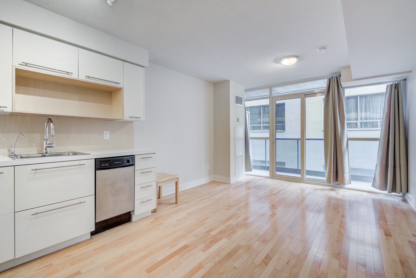 View of 25 Carlton St Unit 401 kitchen, dining room and balcony.