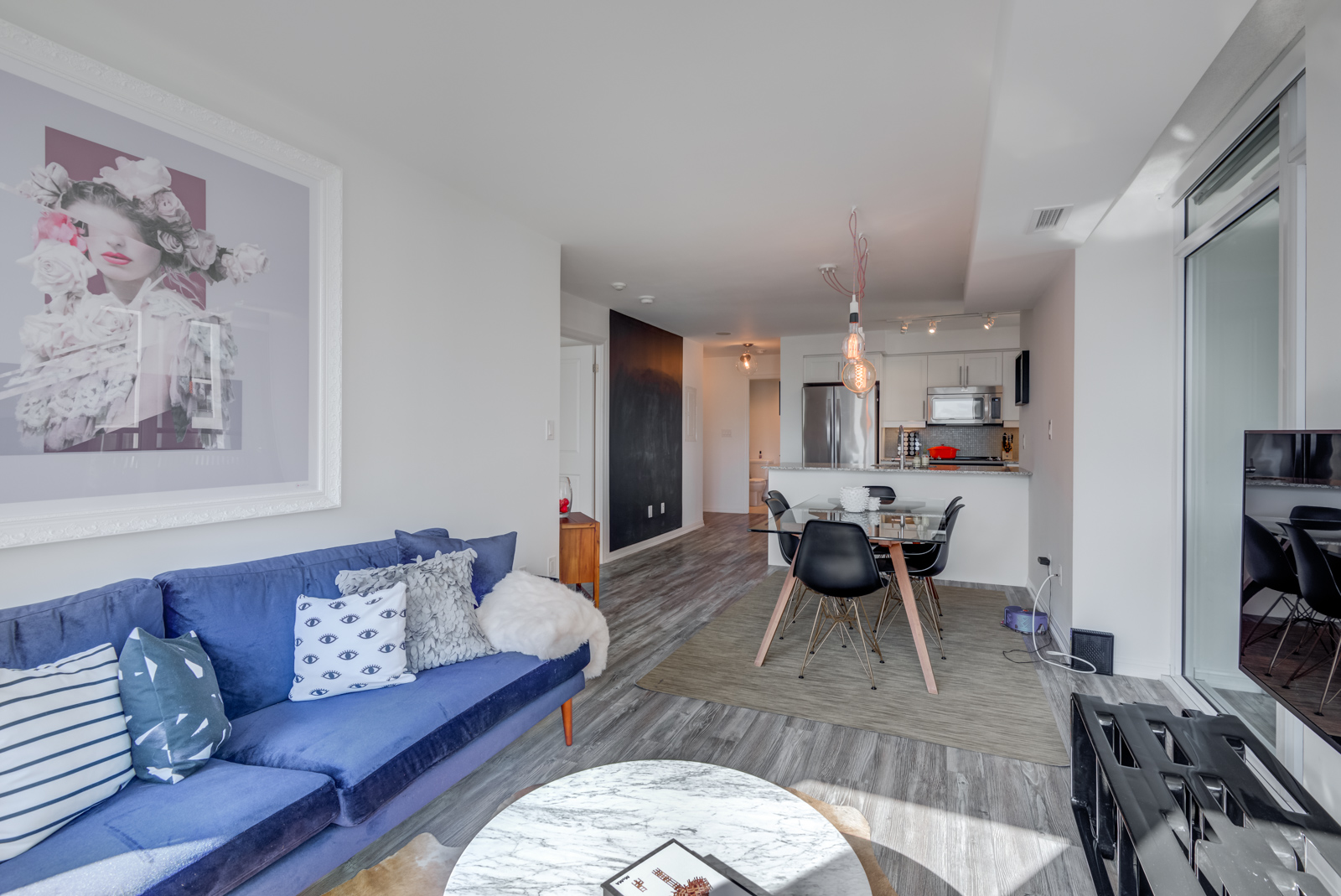 Dark laminate floors in living and dining room of 400 Adelaide St E Unit 704 condos in Moss Park.