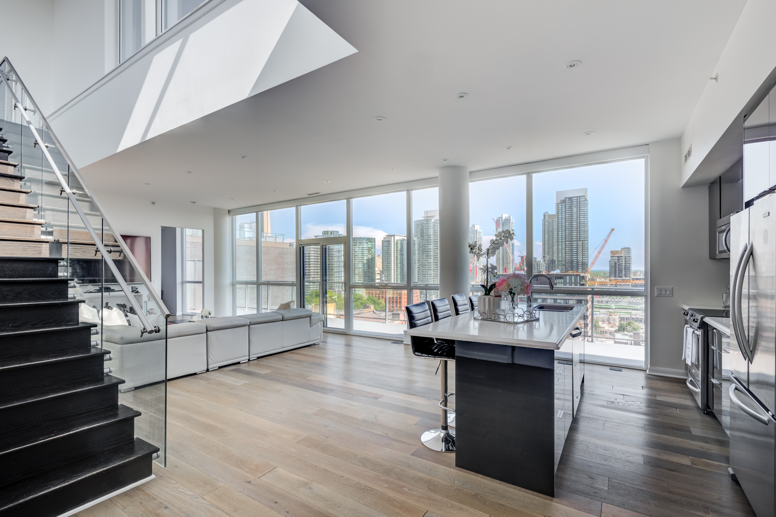 Large, floor-to-ceiling windows at Victory Lofts Penthouse Suite in 478 King St W Toronto.