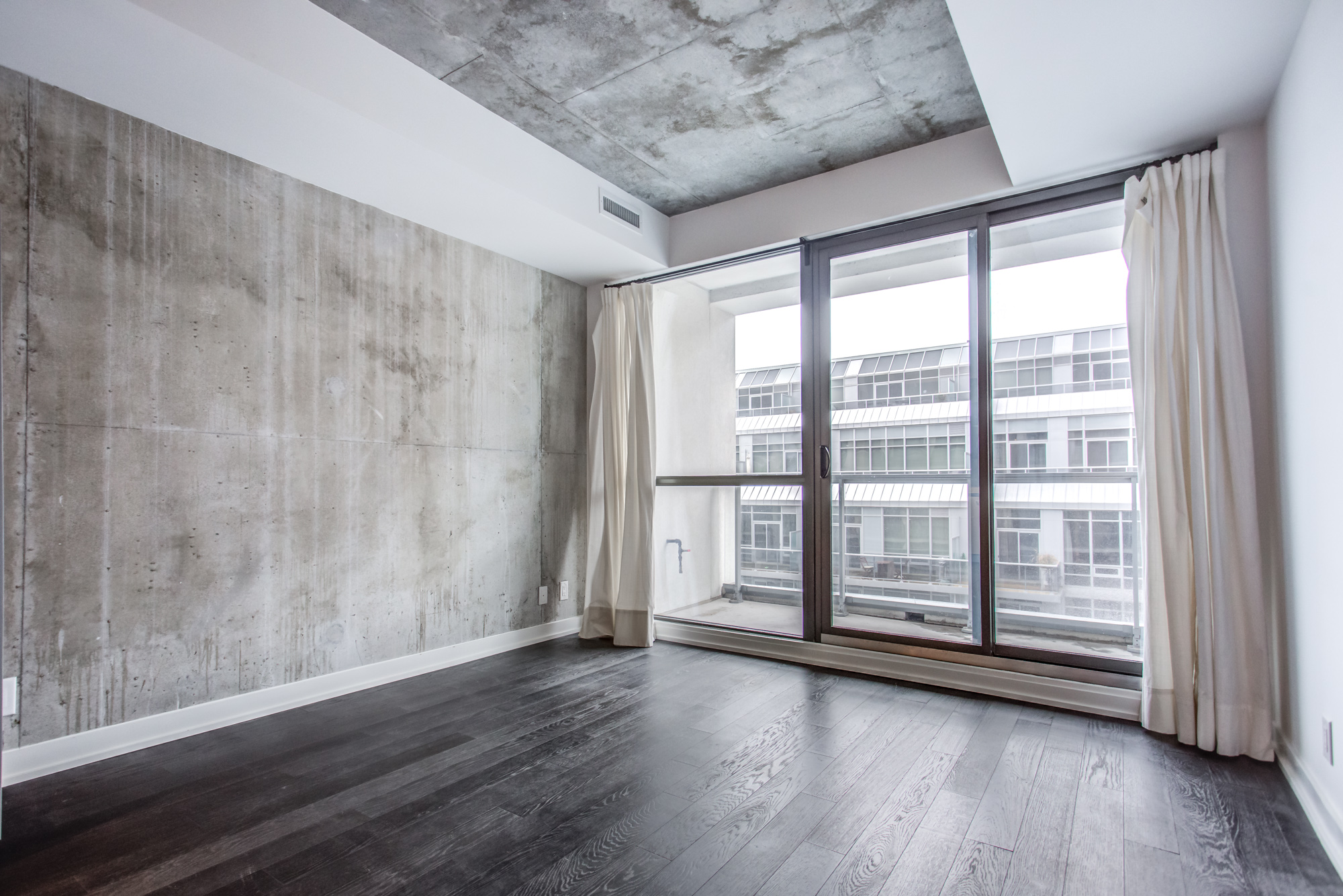 39 Brant St Unit 918, Brant Park Lofts, in Queen West with huge windows and exposed concrete wall and ceiling.