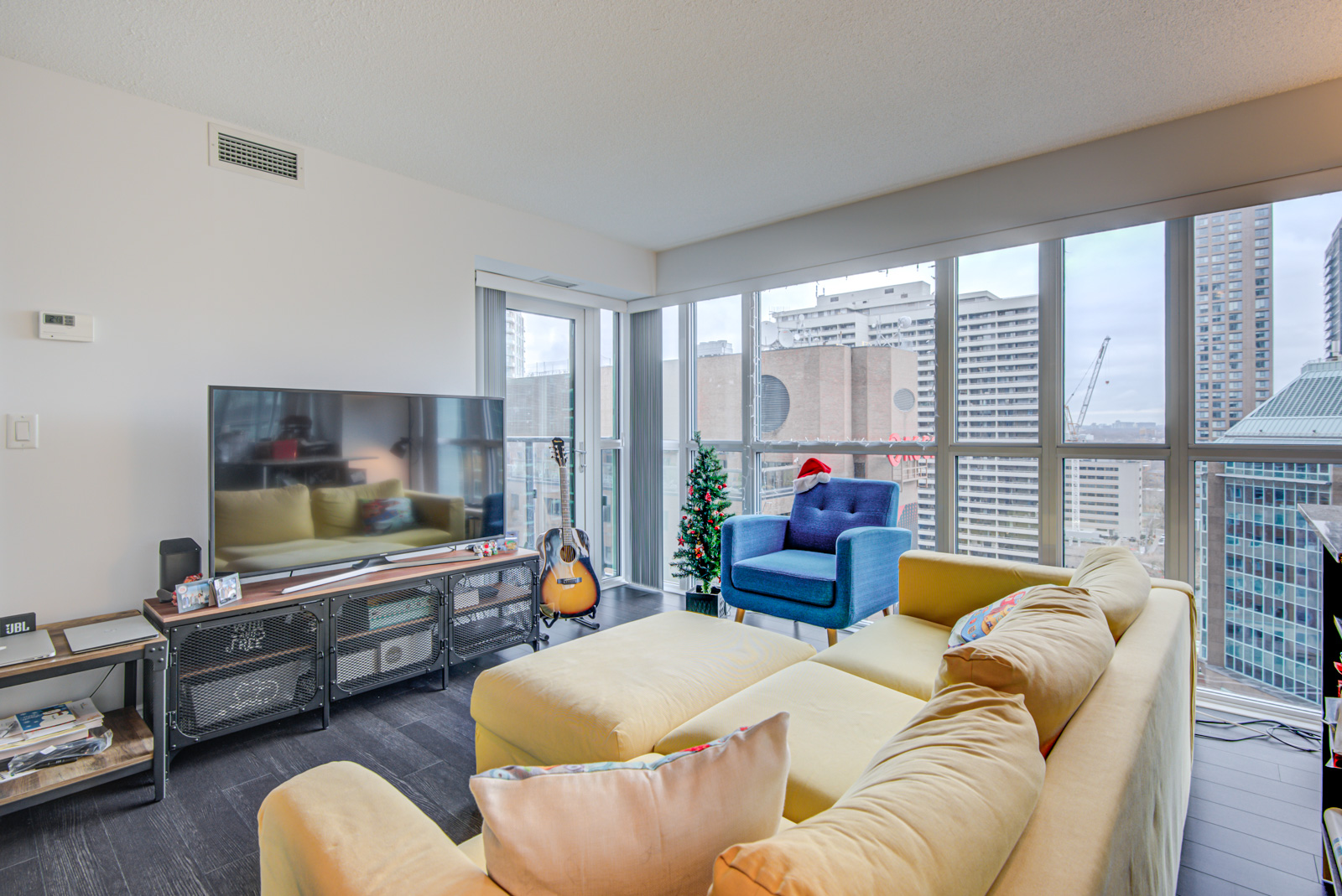 Open-concept living room and dining room at 28 Ted Rogers Way Unit 1702.