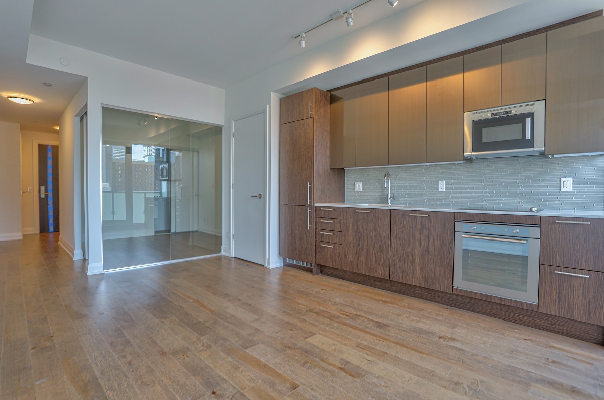 403 Church St Unit 1101 kitchen and bedroom with glass walls.