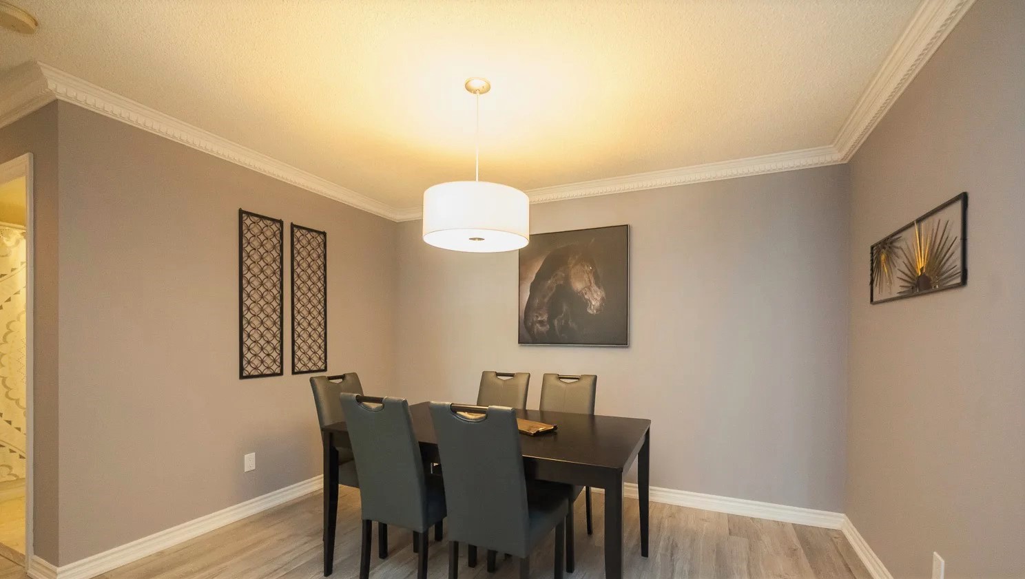 168 Simcoe Suite 1013 dining room with square table and 5 black chairs.