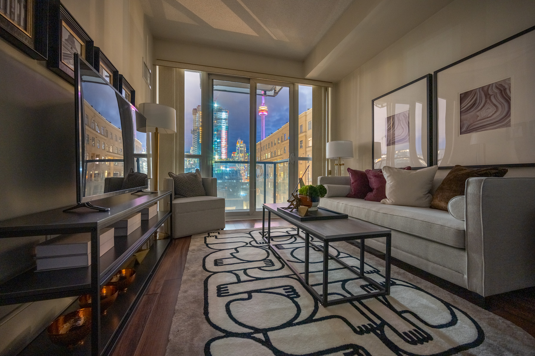 Glowing lights of CN Tower and Toronto as seen from living room of 560 Front St W Unit 622.