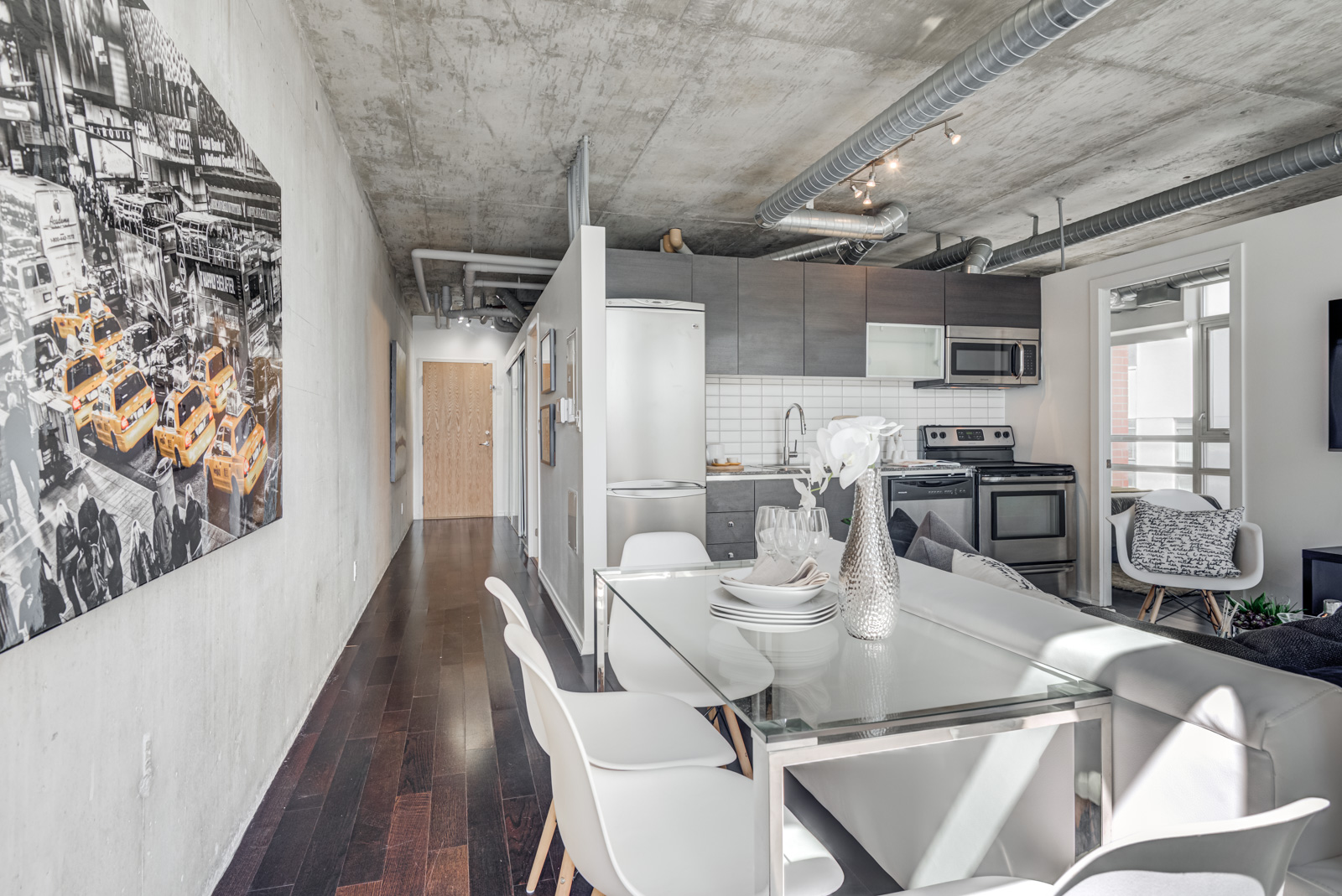 Condo dining room and long feature wall with large photograph.