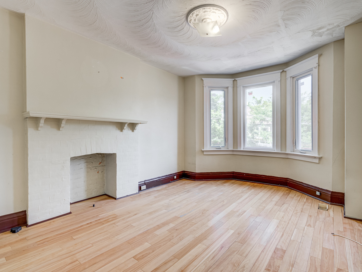 Empty second floor bedroom with large windows and hardwood floors at 51 Rusholme Park Crescent.