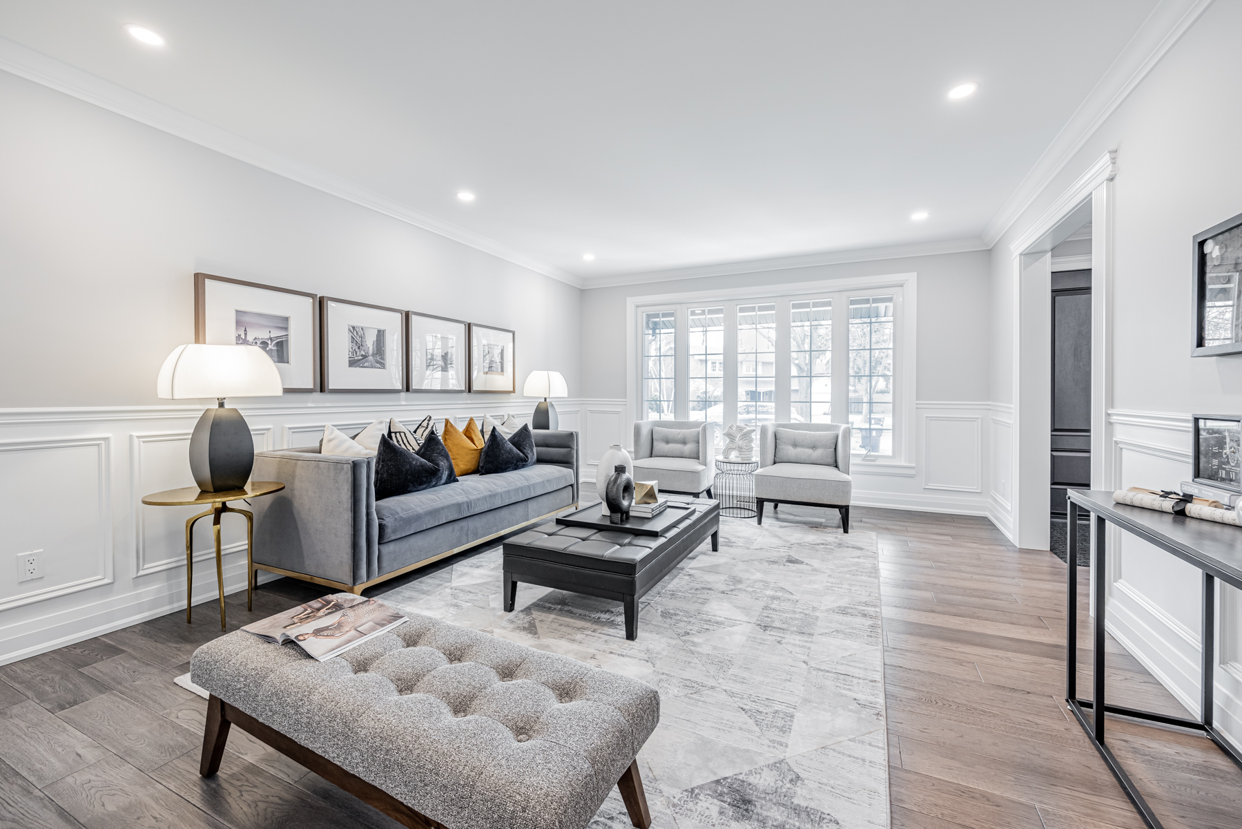 Brightly lit family room with large windows.