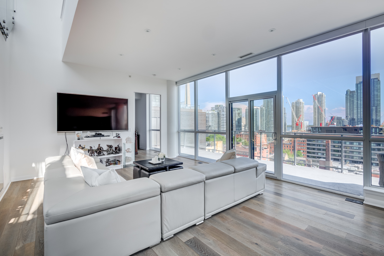 Open concept living room with furniture and windows - Victory Lofts Penthouse Suite in 478 King St W Toronto.