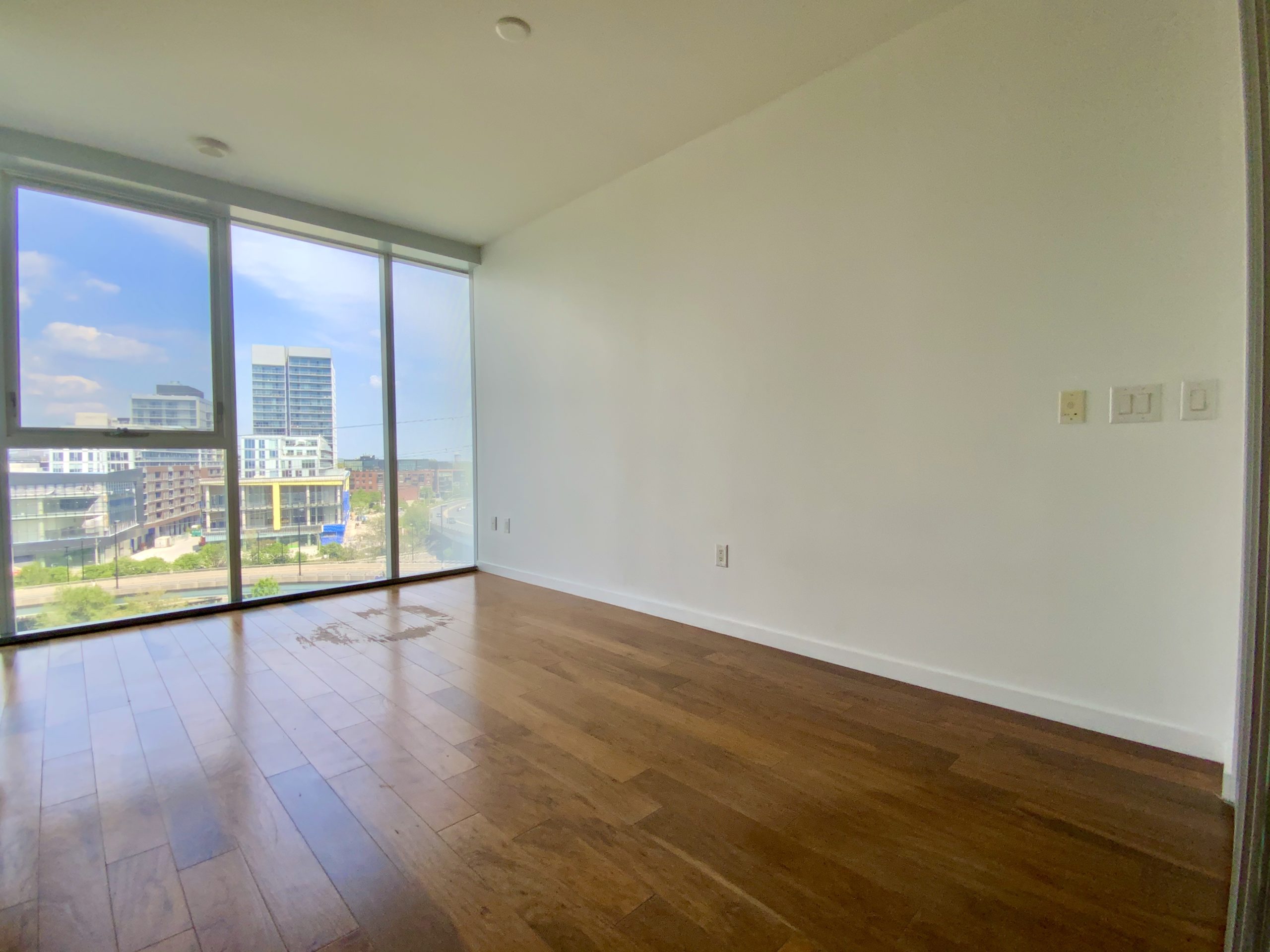 Shiny laminate floors in condo living room - 32 Trolley Crescent Suite 803.
