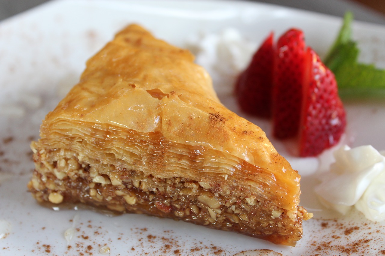 Greek baklava on a plate with strawberries.