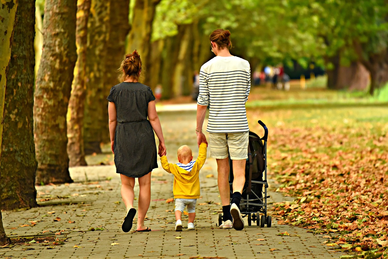 Photo of couple and their child at park.