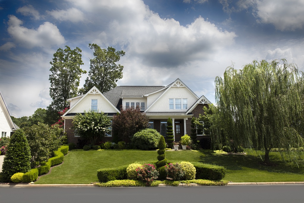 House and beautiful front yard showing importance of creating curb appeal pre-listing tip for sellers.