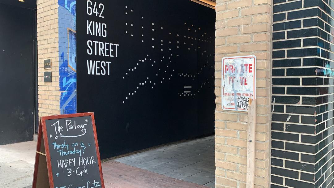 Chalkboard sign and address for The Parlour restaurant on 642 King West.