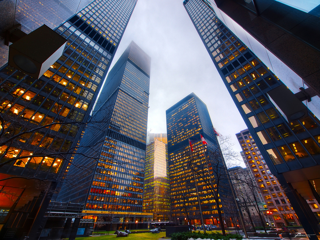 Photograph of buildings in Toronto's Financial District. We can see so many lights, but less of their tops because of the fog.