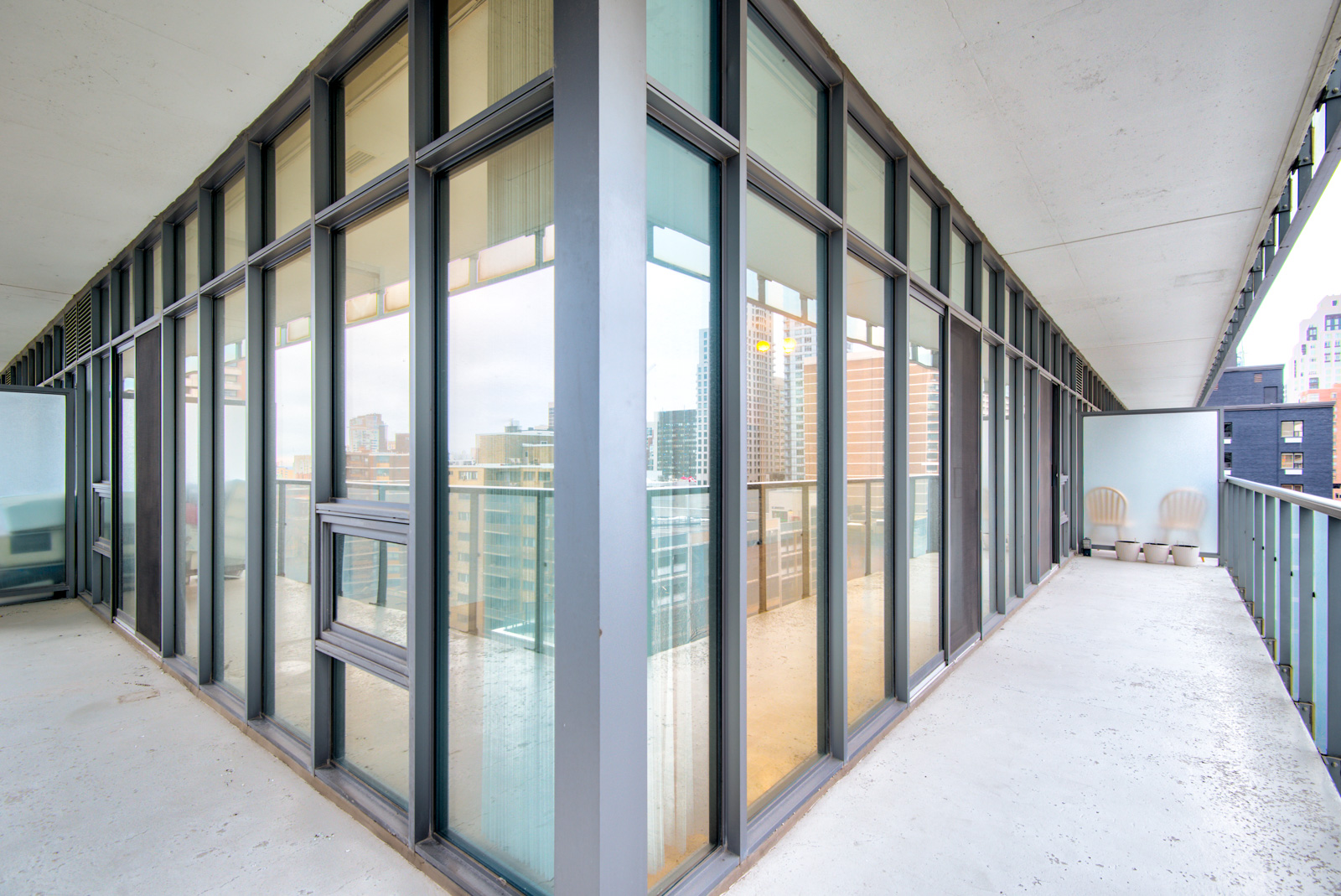 Casa Condos - Balcony view of 33 Charles St E Unit 911 showing wrap-around style.