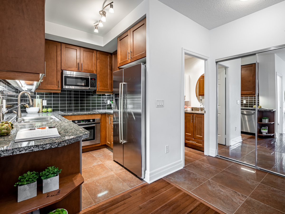 35 Balmuto St Unit 1407 u-shaped kitchen with shelves mounted to counter-tops.