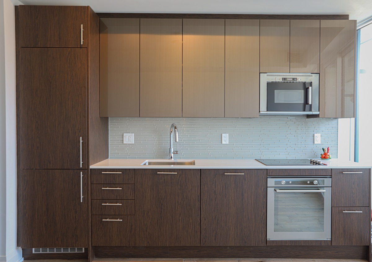 Linear kitchen with recessed appliances.