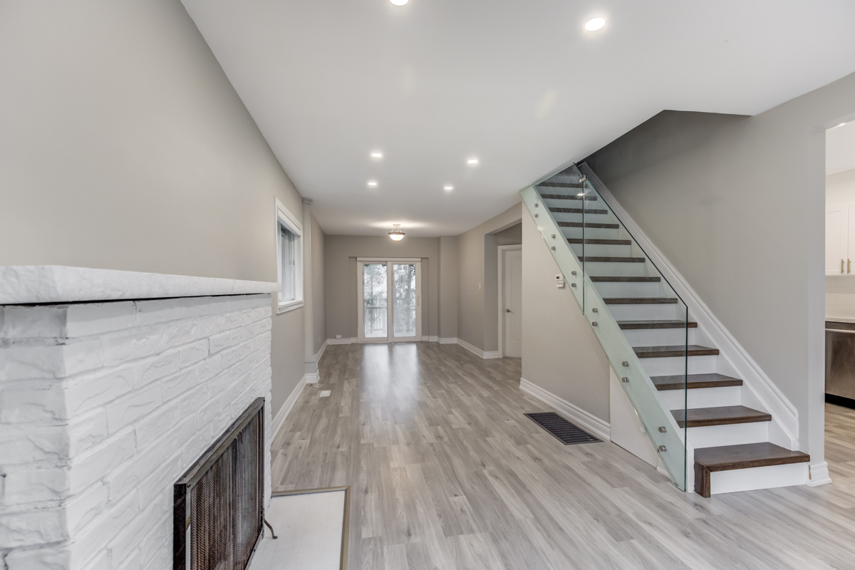 Close up of 54 Huntington Ave living room's white brick fireplace.