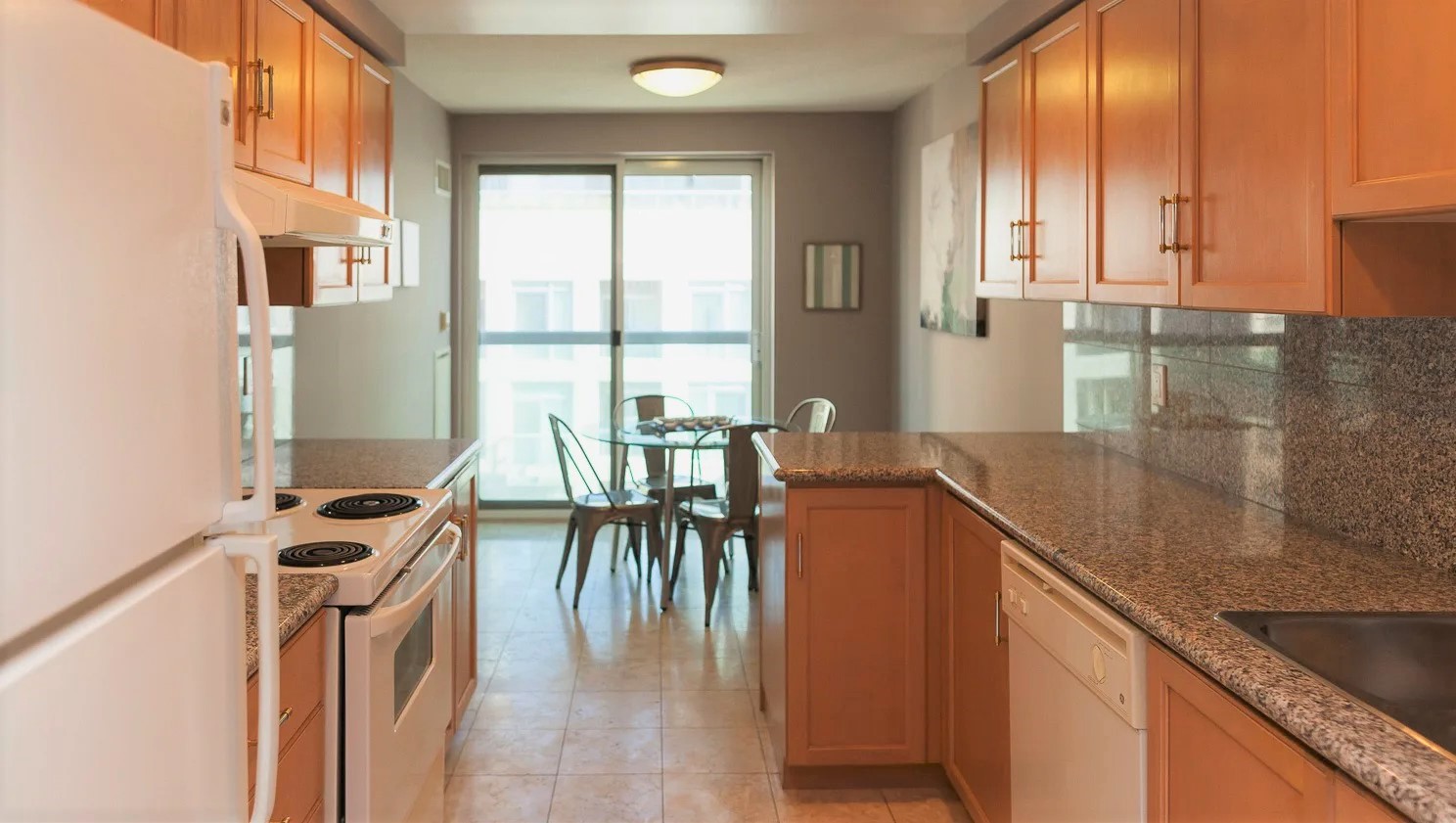 Eat-in kitchen with cabinets on either side.