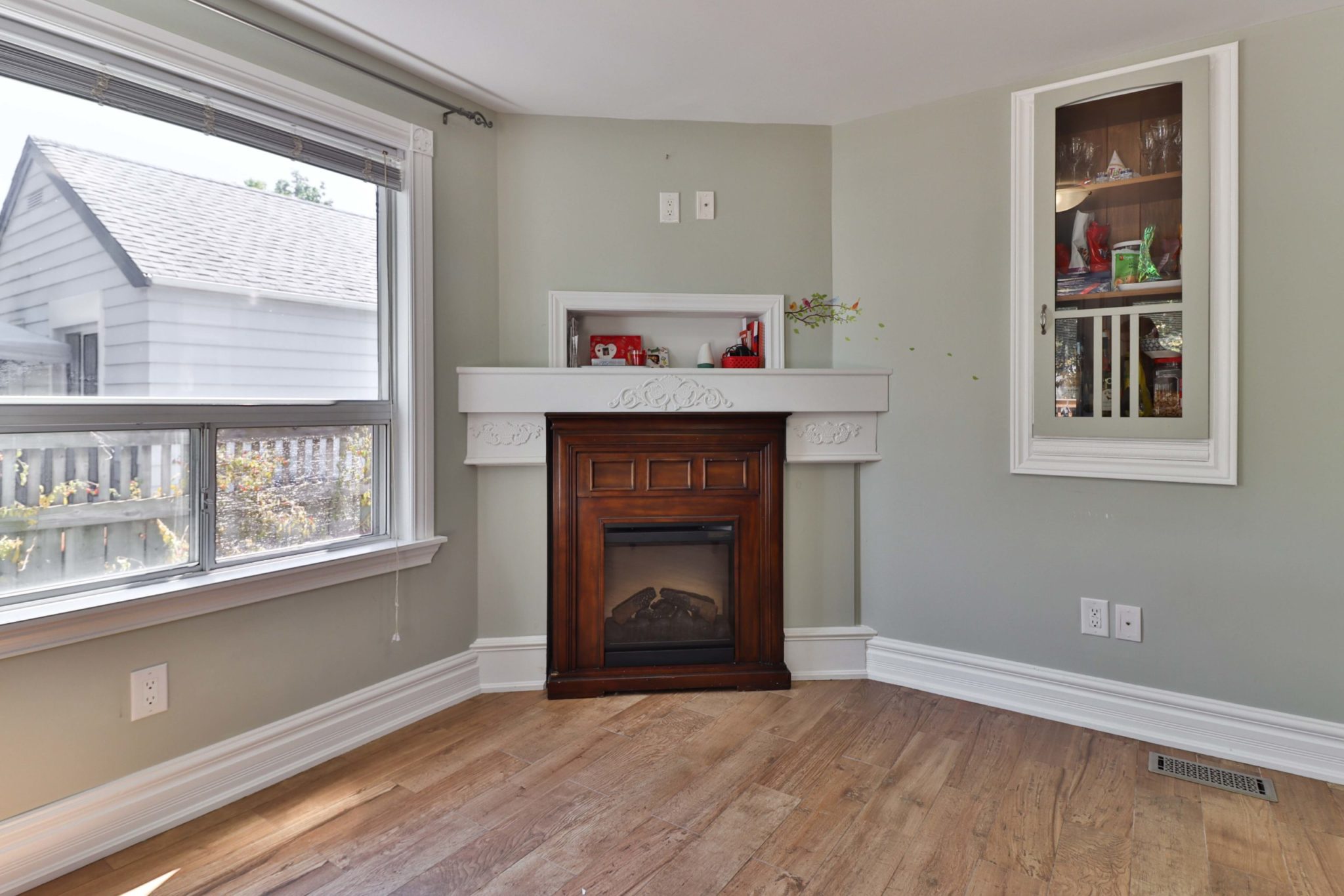 Wood fireplace and mantle in dining room.