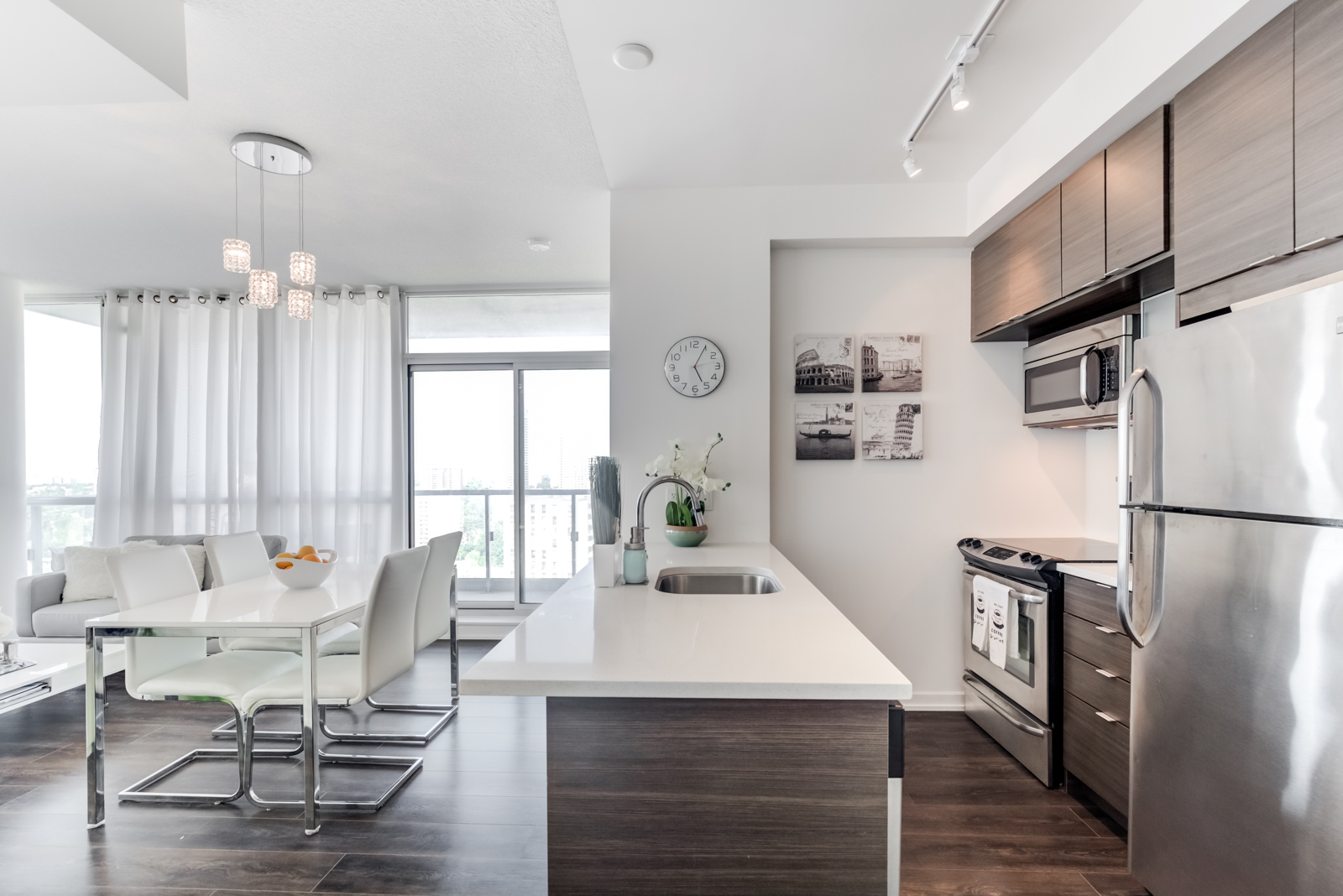 Breakfast bar with dark base and view of kitchen cabinets and appliances at 62 Forest Manor Rd Unit 1803, Toronto.