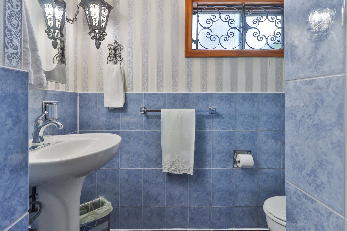 Basement bathroom with chic blue tiles, gray wallpaper and walk-in shower - 6 Parmbelle Cres