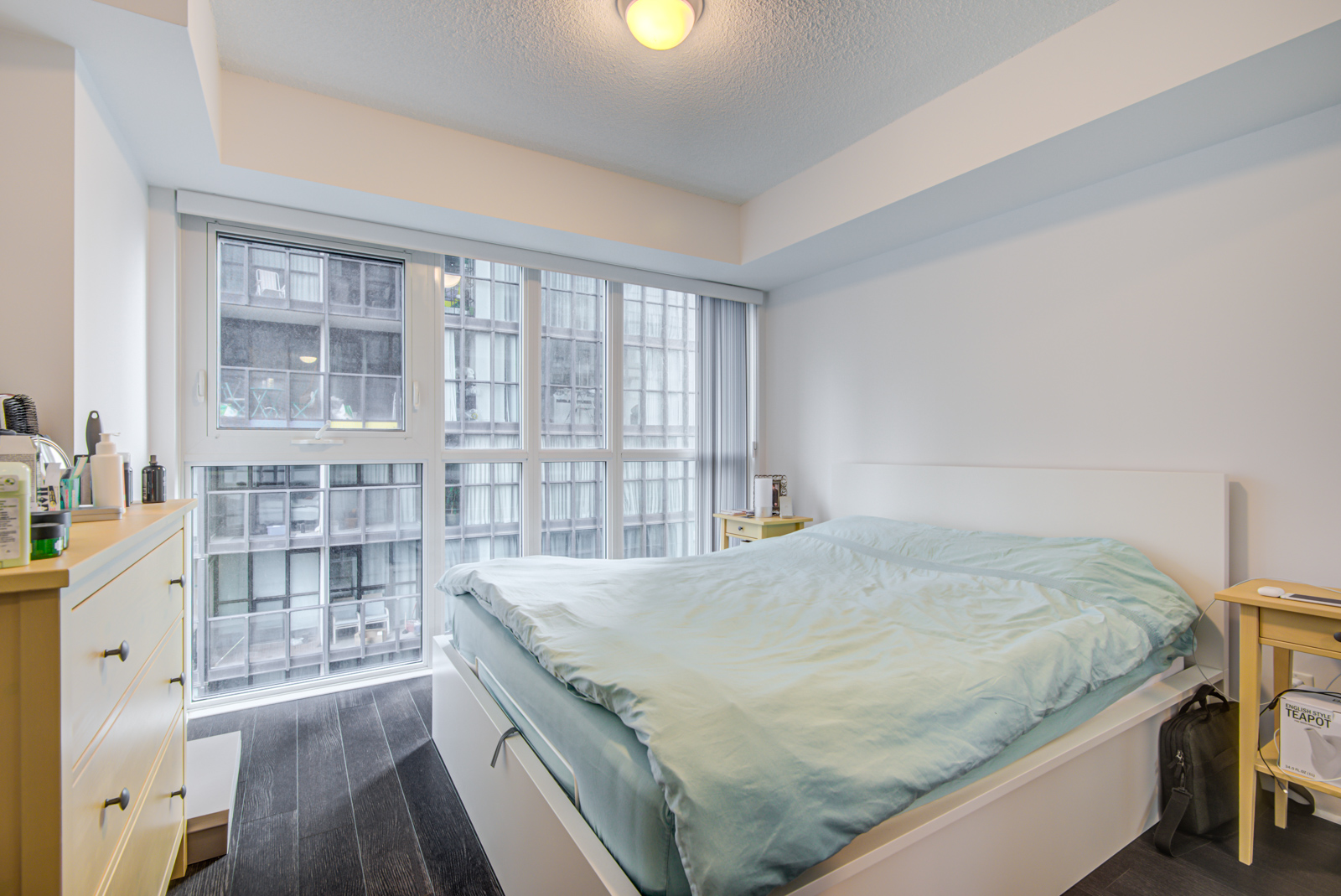 28 Ted Rogers Unit 1702 master bedroom with large bed, floor-to-ceiling windows and gray walls.