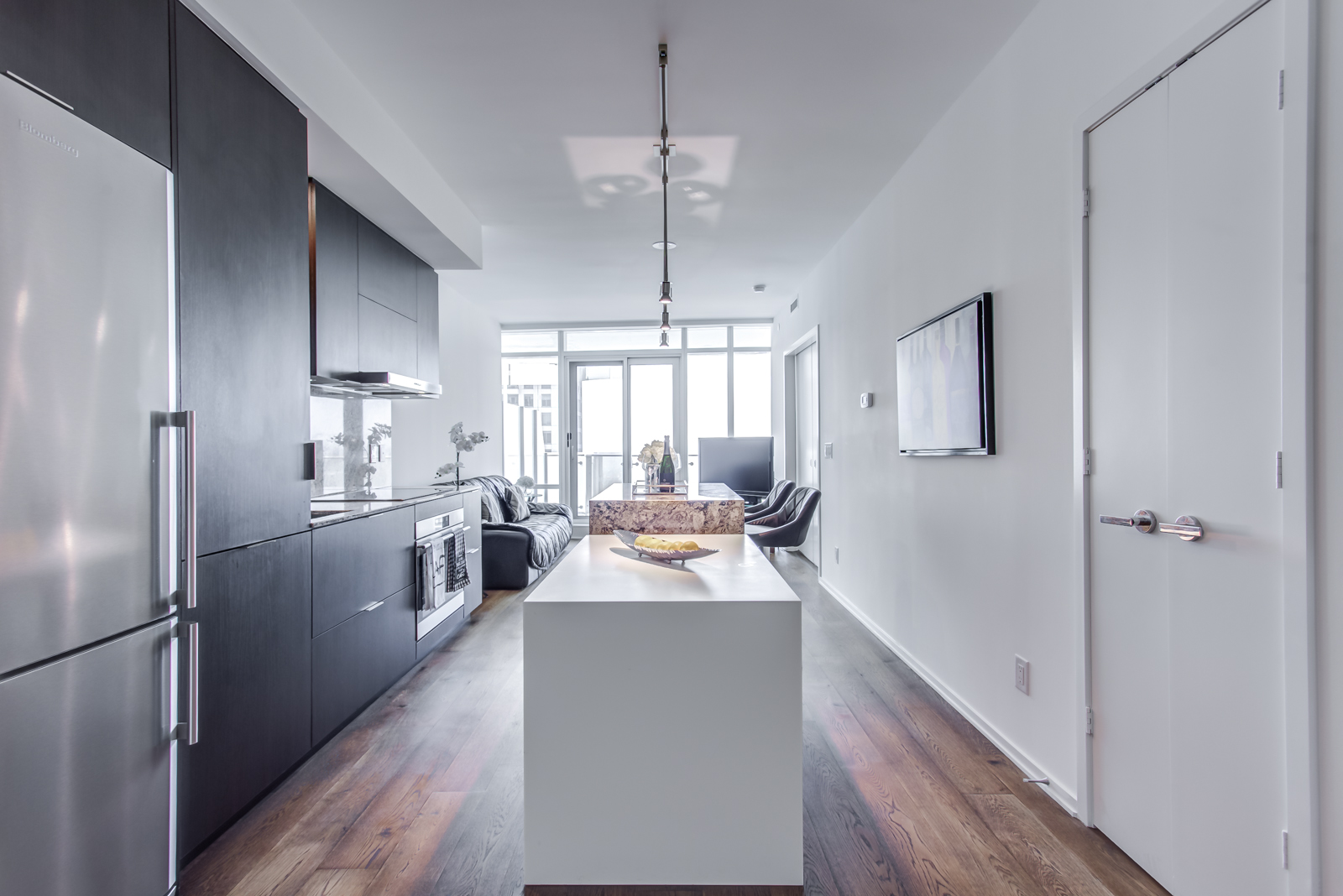 Dining table and kitchen of 1 Bloor St E Unit 3408.