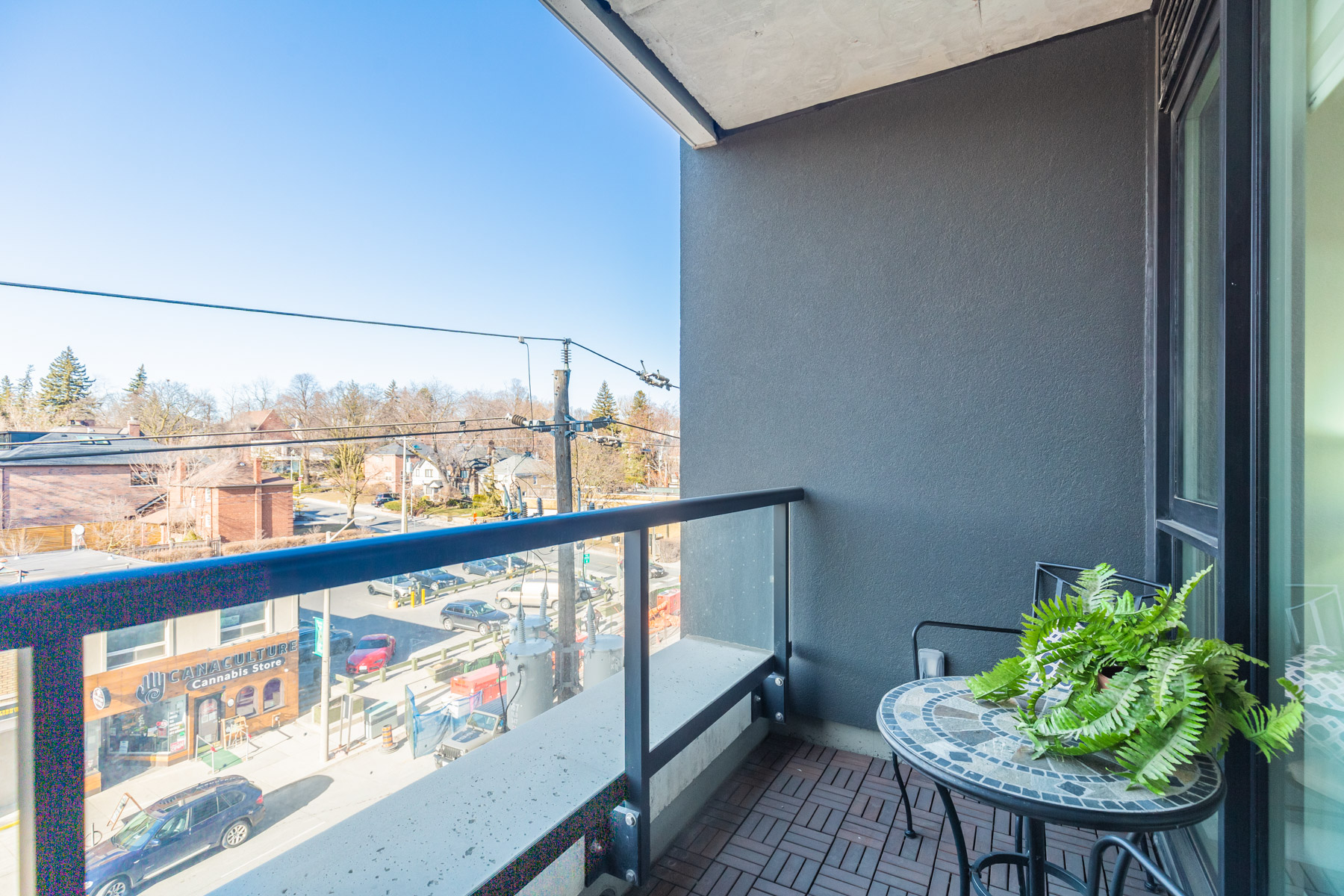 170 Chiltern Hill Rd Unit 410 balcony with parquet floors and glass panels.