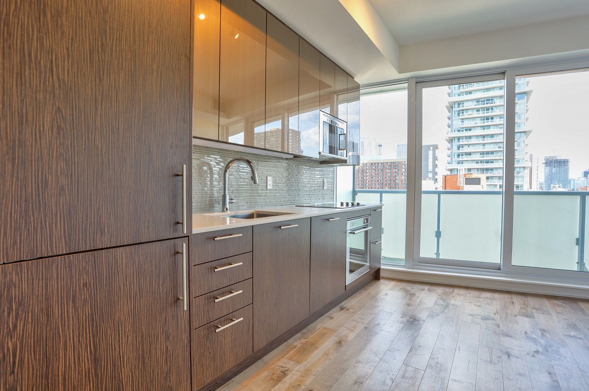 Brightly lit 403 Church St kitchen with glossy upper cabinets.