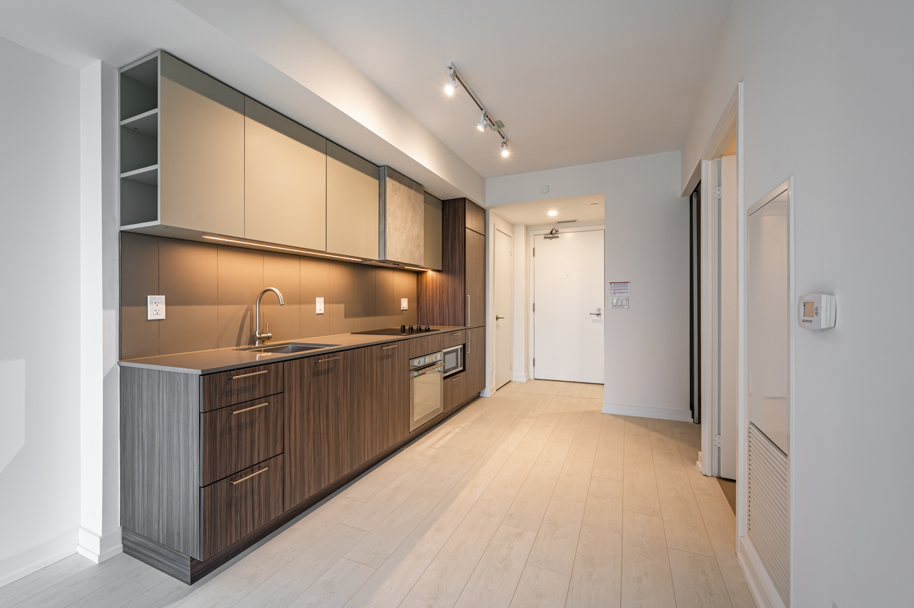 Condo kitchen cabinets with side cubbies.