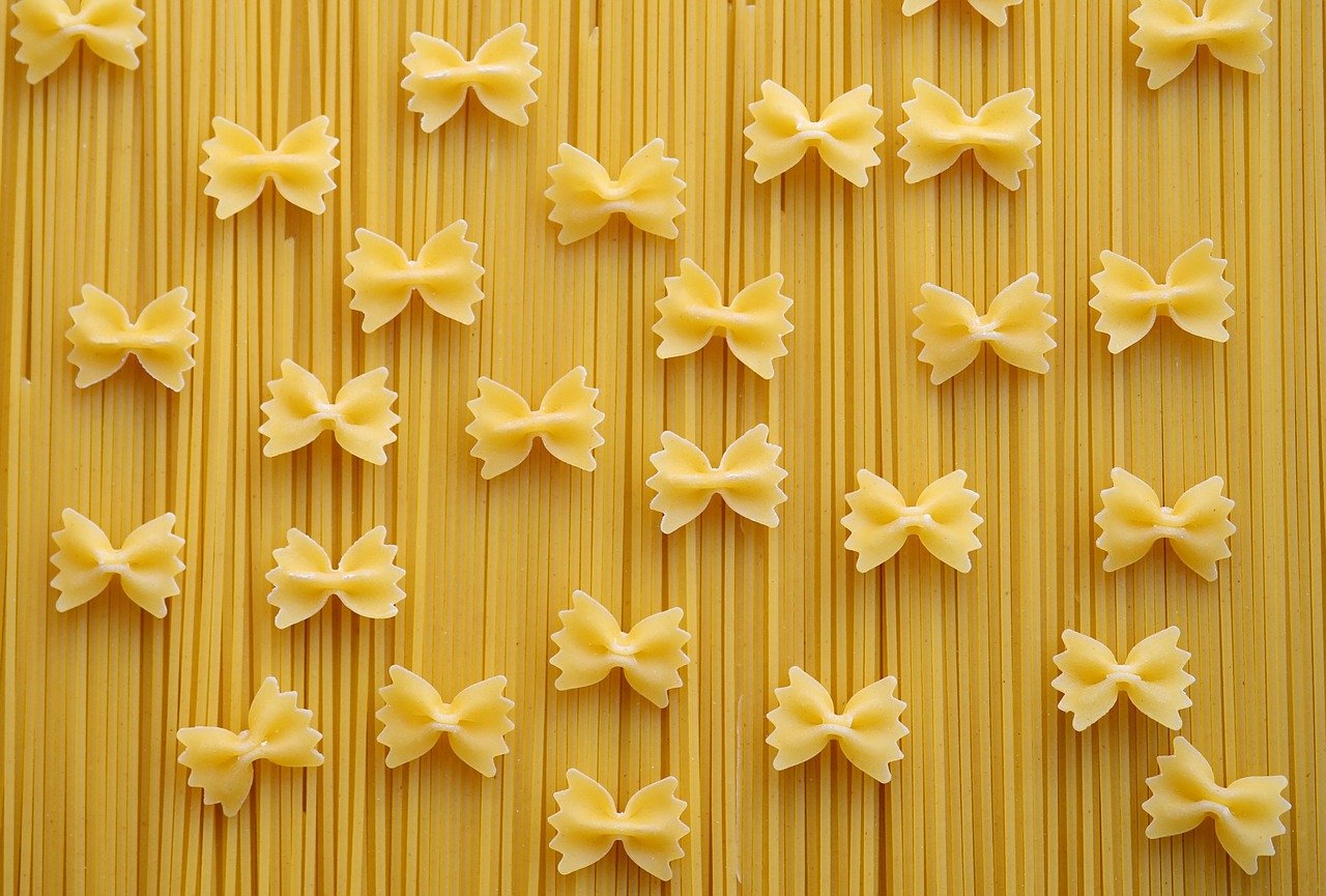 Uncooked bow-tie pasta and spaghetti.