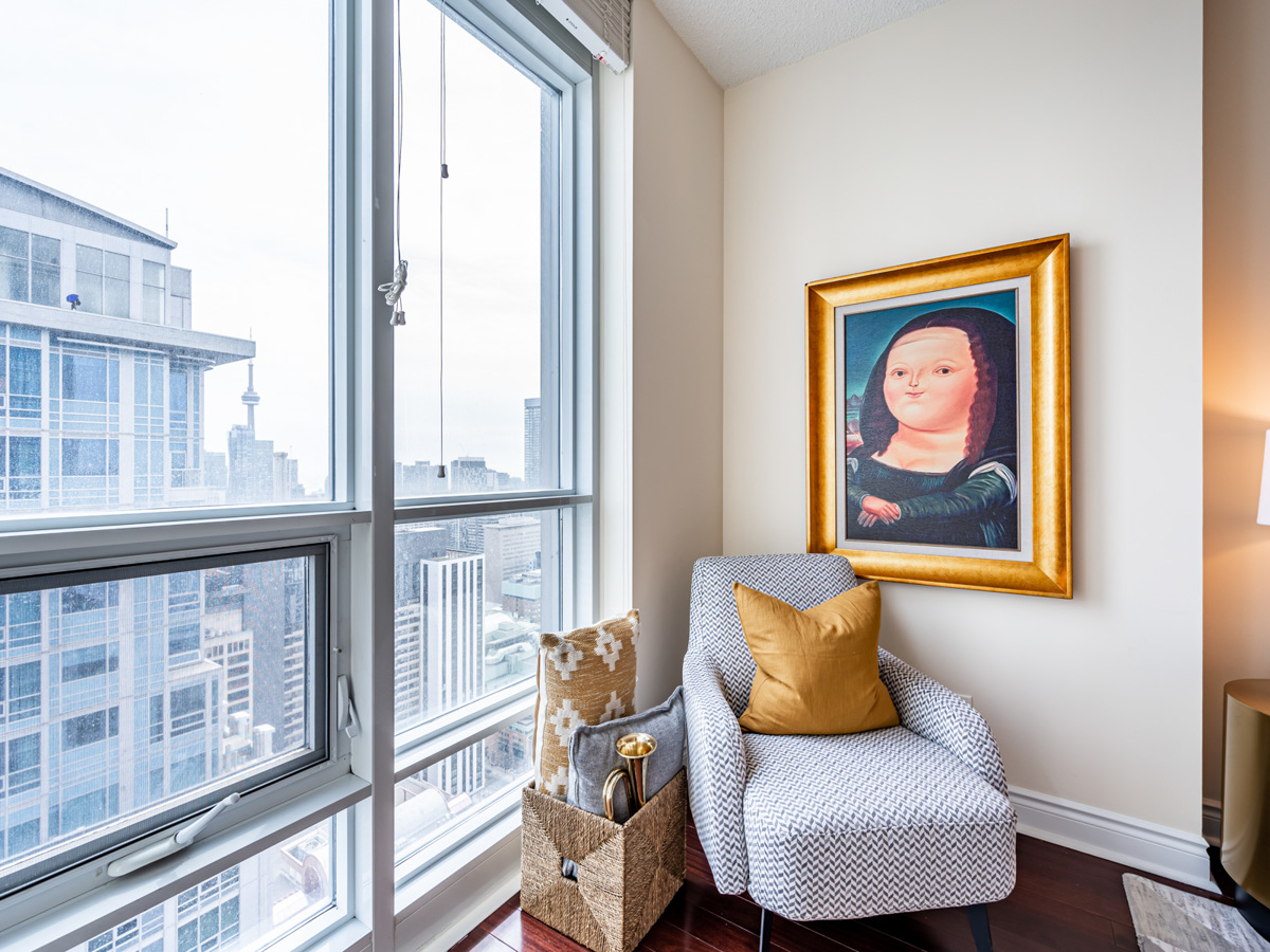 Toronto skyline and CN Tower from 763 Bay St Unit 4705 living room windows.