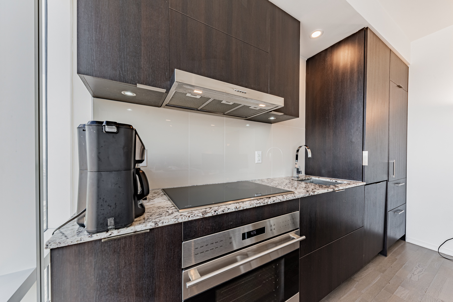 Sleek condo kitchen with large cabinets.