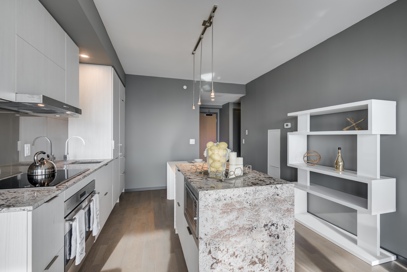 Close up of granite kitchen island with built-in microwave.