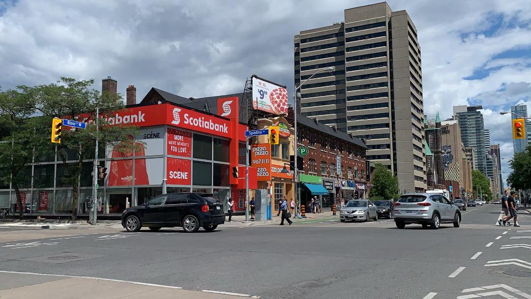 Signs and billboards for Scotia Bank and Pizza Pizza along Bathurst and Bloor West in The Annex neighbourhood.