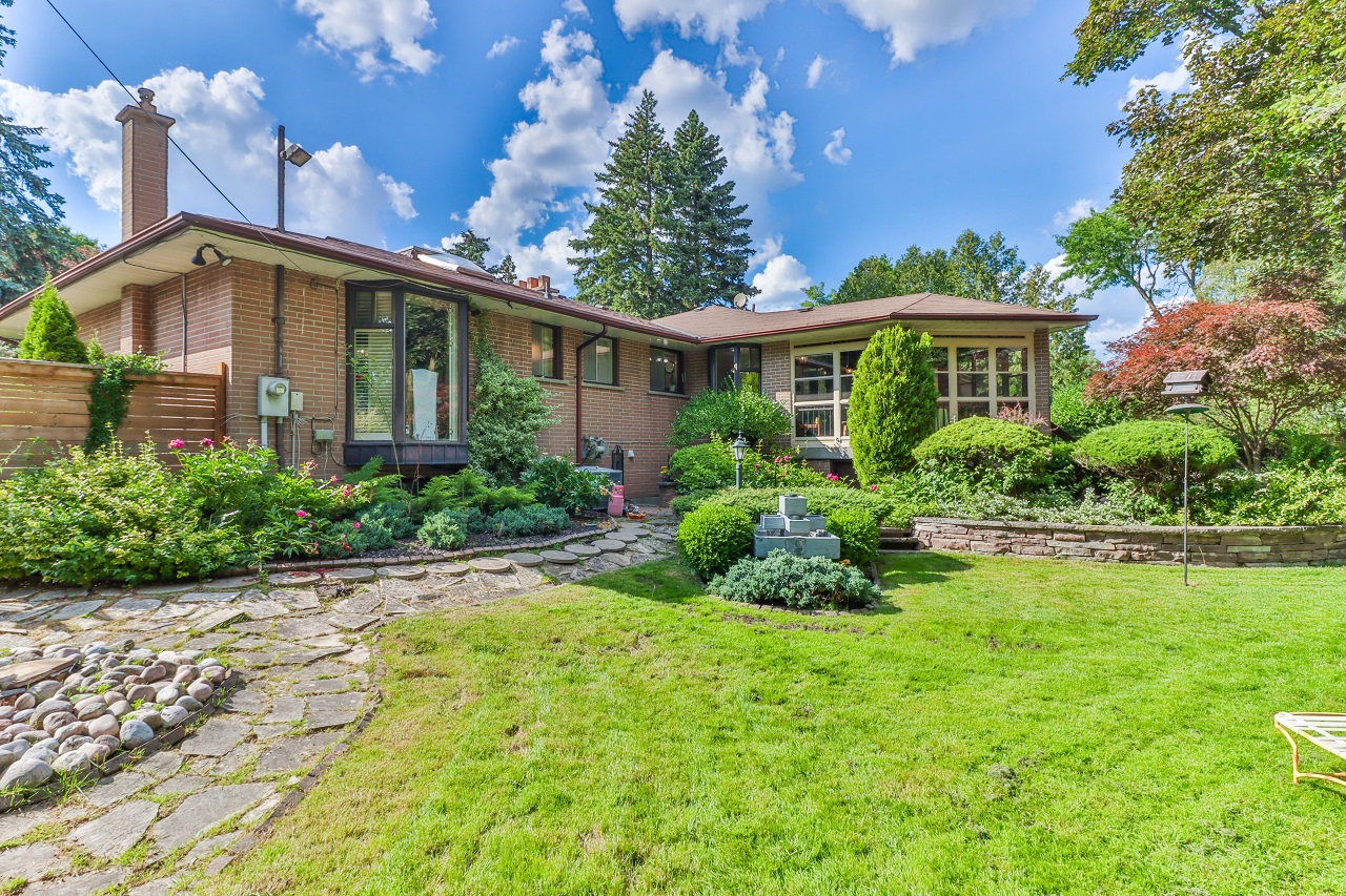 Backyard and exterior of large house showing couple upsizing.