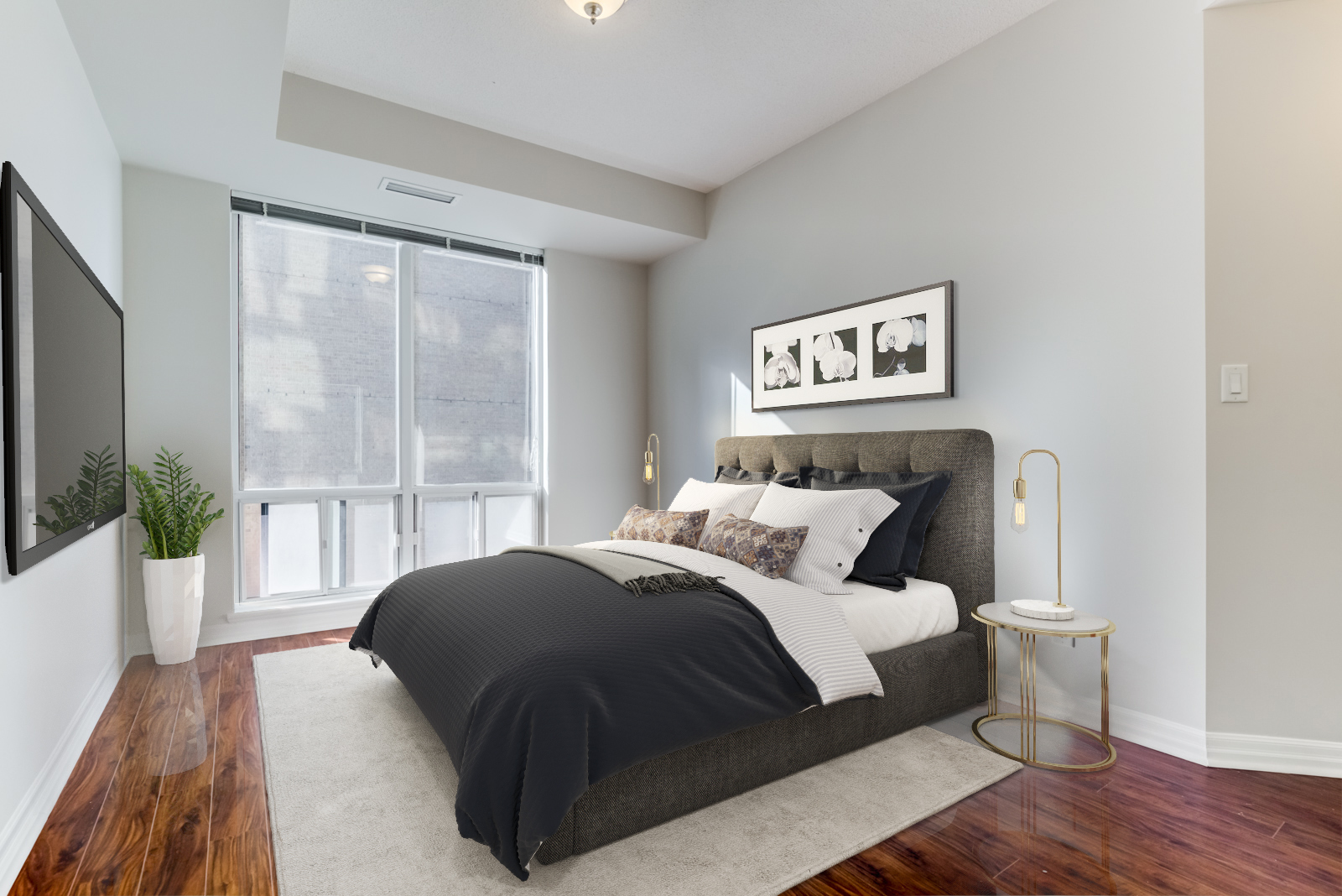 Master bedroom at 300 Bloor St E Unit 1809 with 3D rendered table lamp, carpet and bed with dark sheets.