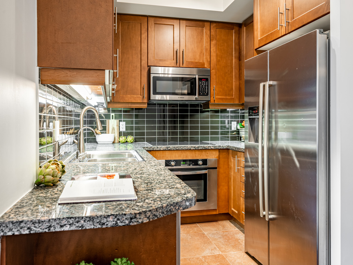 35 Balmuto St # 1407 kitchen with under-cabinet florescent lights and stainless-steel appliances.