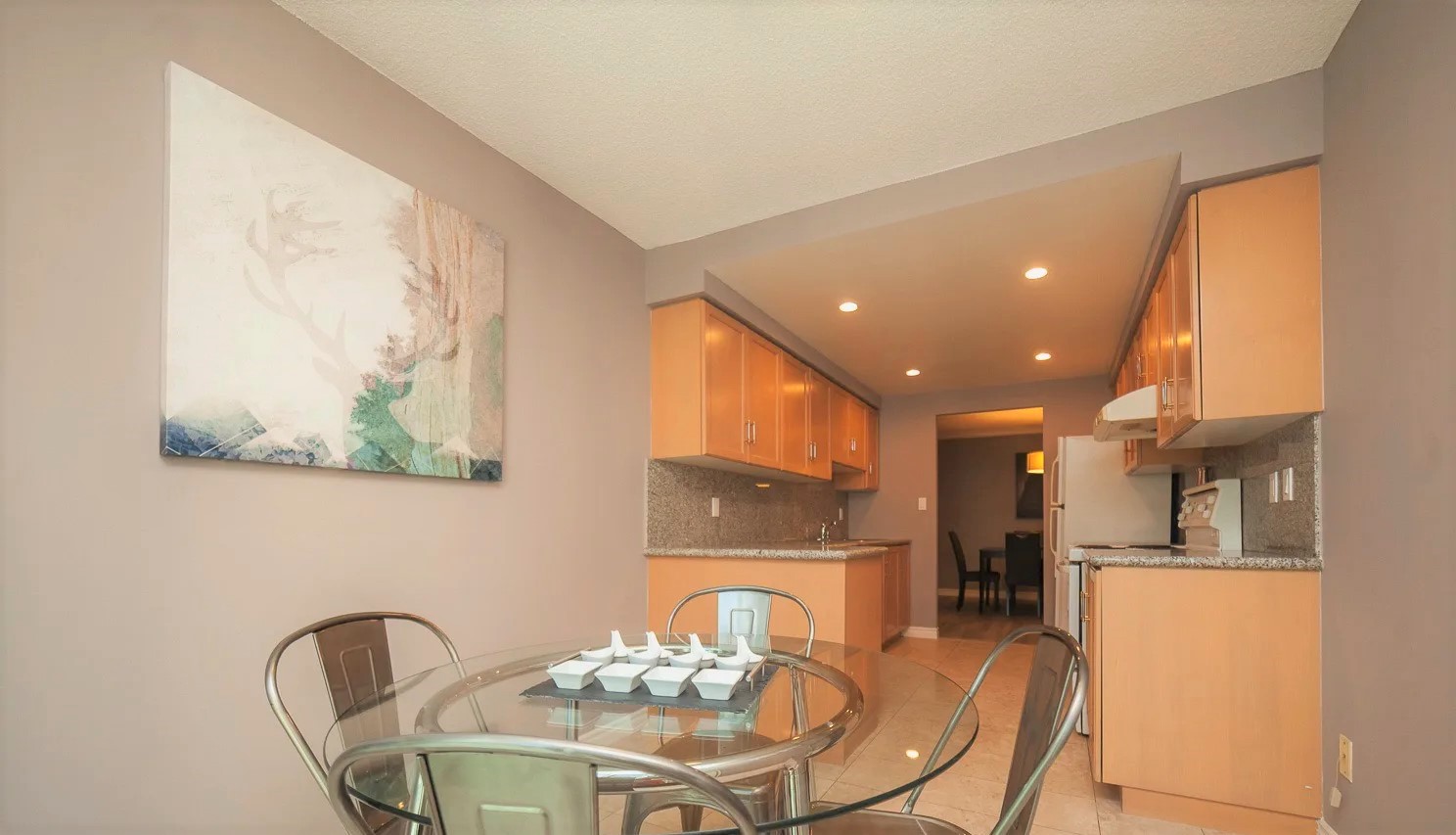 Eat-in kitchen with glass dining table.